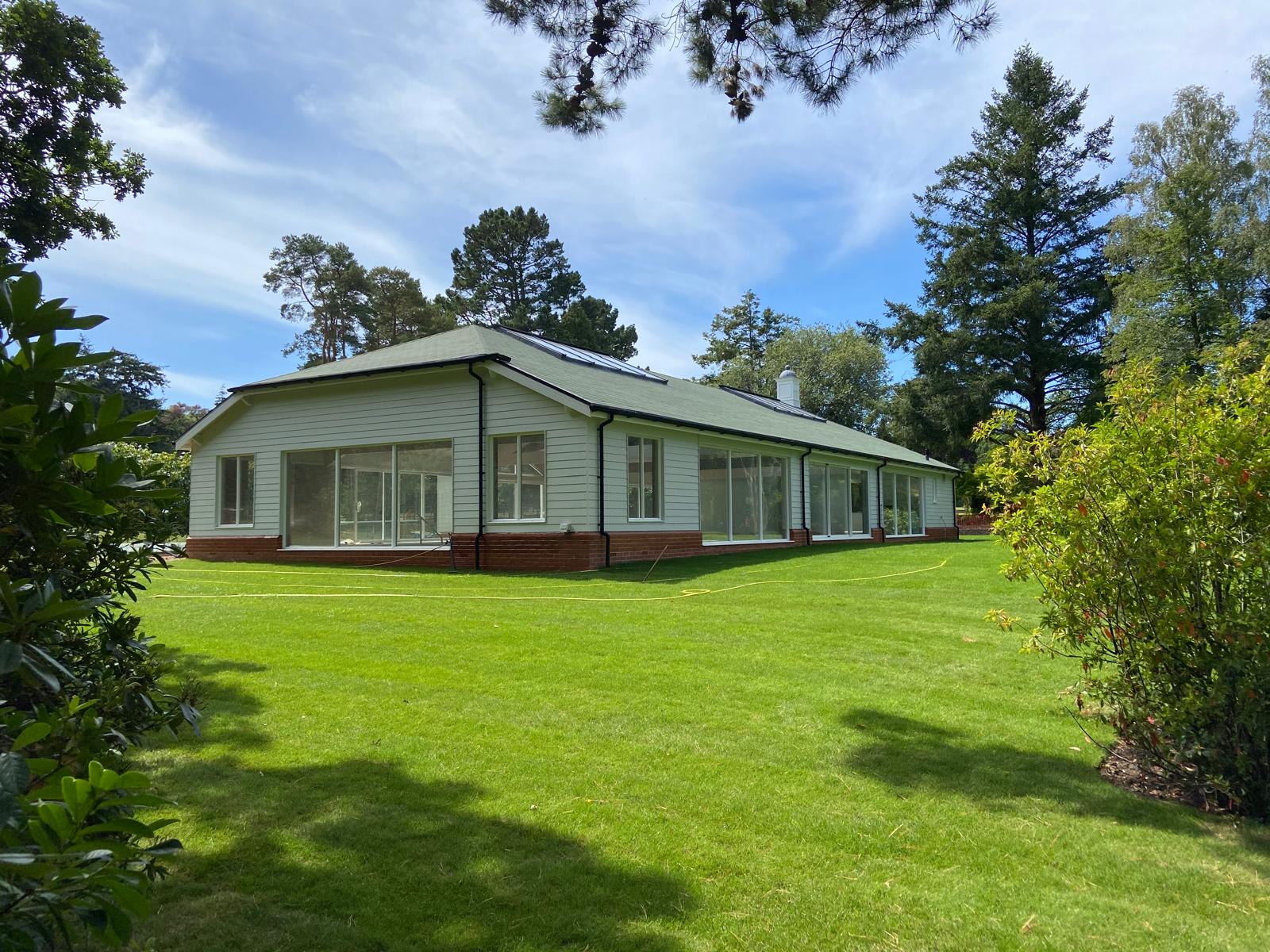 Clean windows on a timber-clad garden building after window cleaning in the New Forest