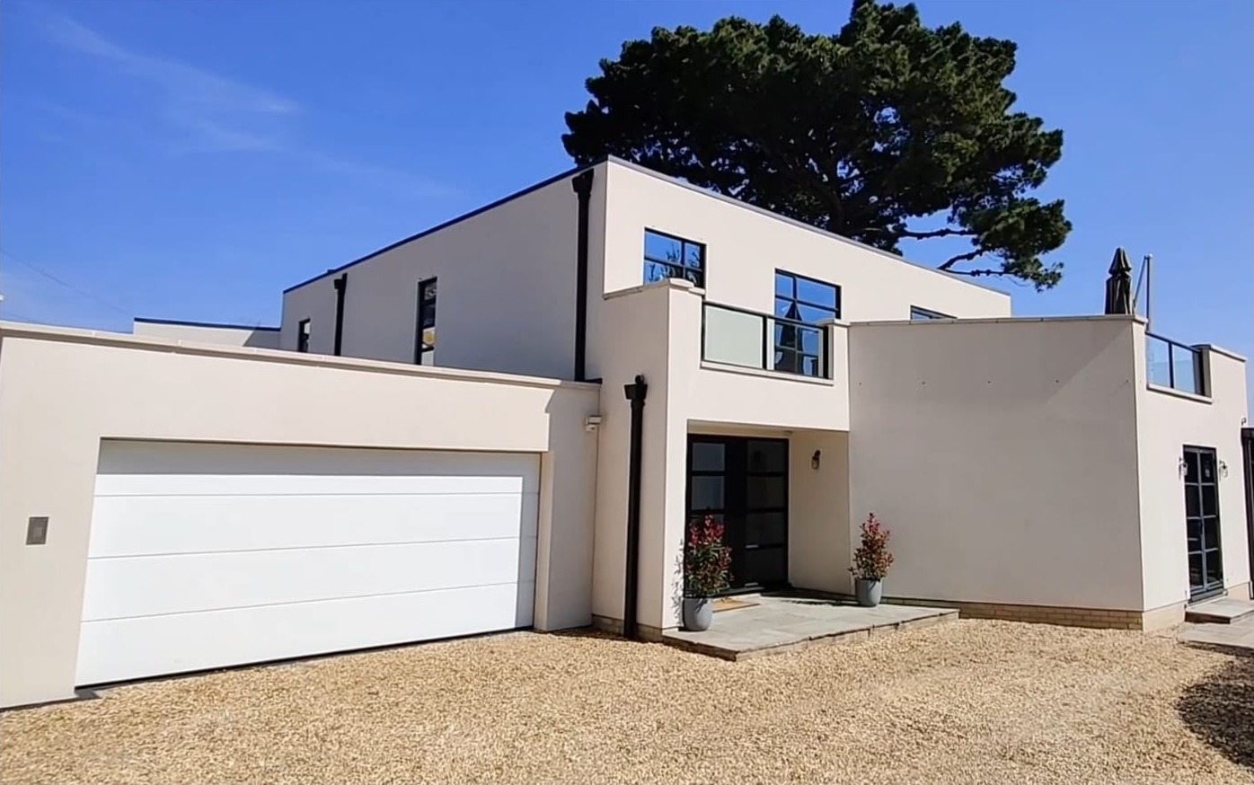 Clean cream render on a modern house and garage after render cleaning in the New Forest